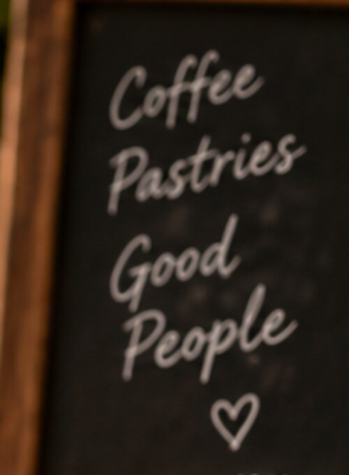 Chalkboard reading Coffee, Pastries, Good People